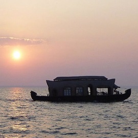 Watching the sunset over Ashtamudi Lake from a boat